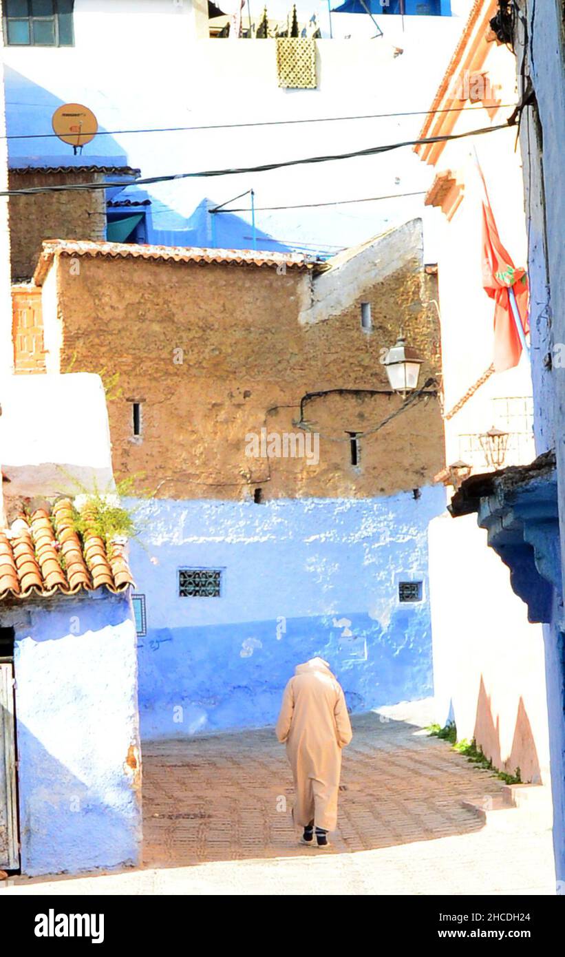 A local man walking through the narrow streets of the medina of Chefchaouen, Morocco. Stock Photo