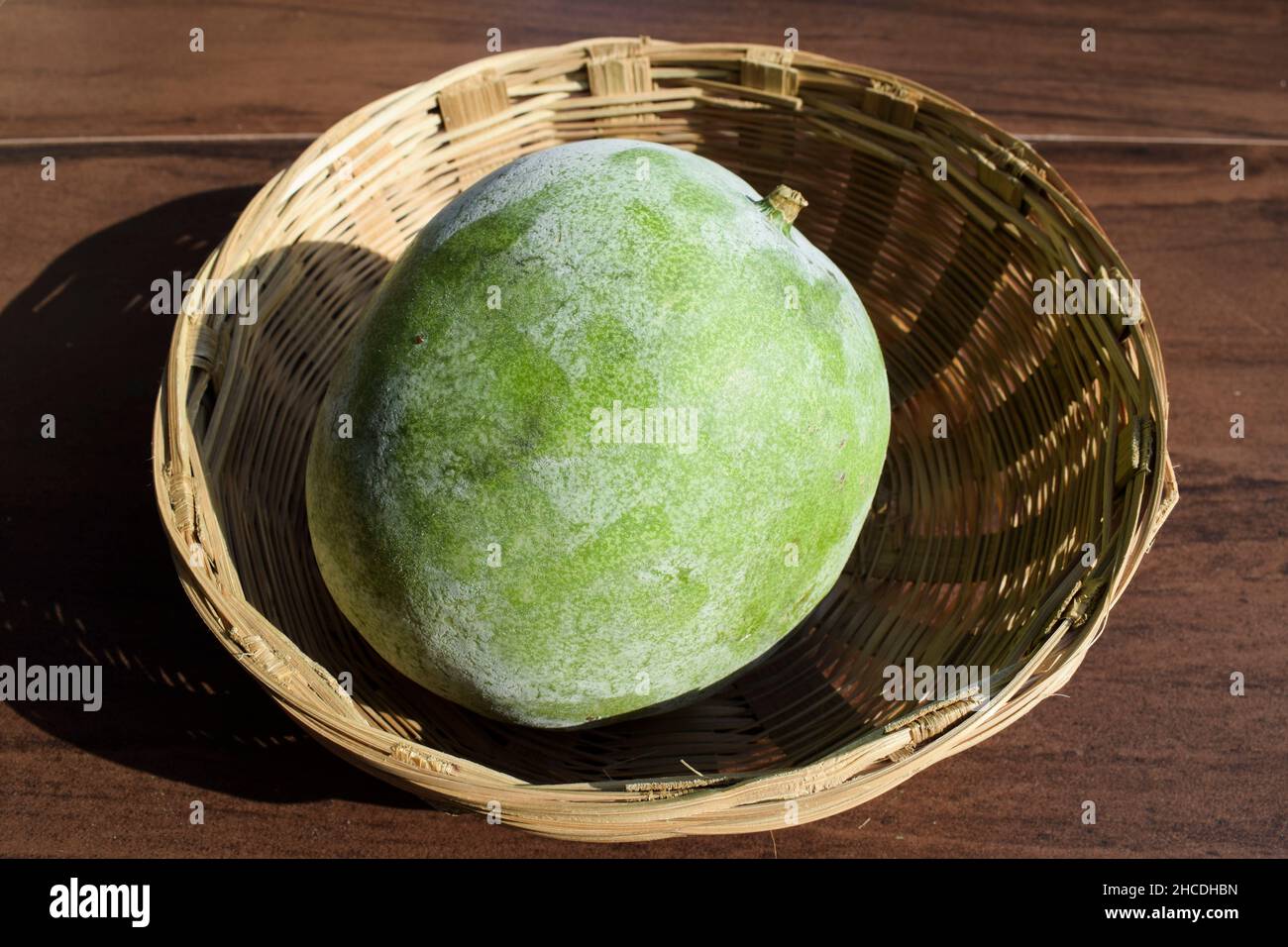 Fresh Indian vegetable called Ash gourd in wicker basket. Indian vegetable in wicker basket Stock Photo