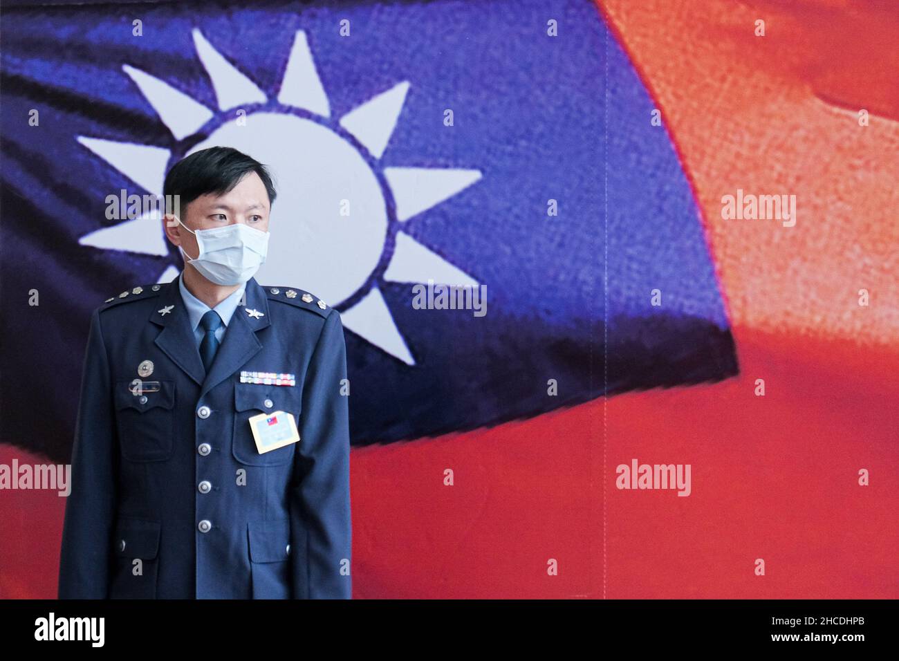 Taipei, Taiwan. 28th Dec, 2021. A Taiwanese military officer stands in front of a Taiwanese flag during a ceremony for promotion of generals and officers at the Taiwanese ministry of defense. Credit: SOPA Images Limited/Alamy Live News Stock Photo