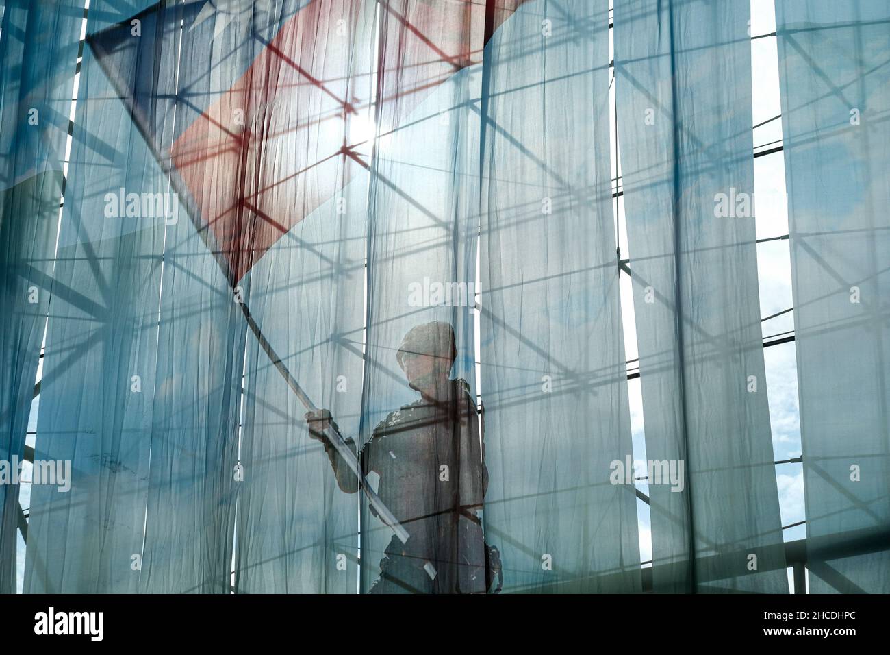 Taipei, Taiwan. 28th Dec, 2021. Printed picture of a Taiwanese military holding a Taiwanese flag on a curtain during a ceremony for promotion of generals and officers at the Taiwanese ministry of defense. Credit: SOPA Images Limited/Alamy Live News Stock Photo