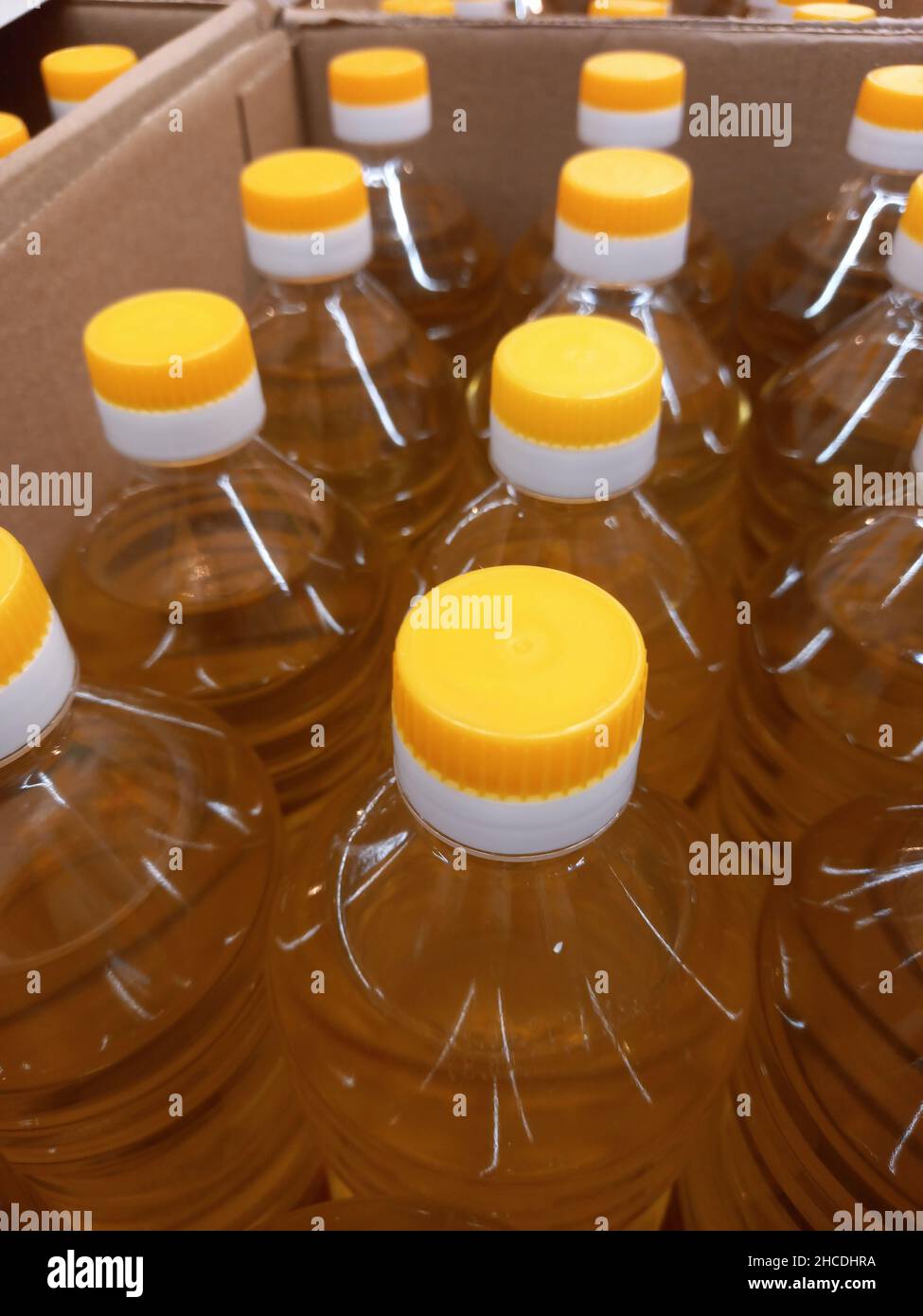 Vegetable oil in plastic bottles in a box. Selling vegetable oil in a market or store. Stock Photo