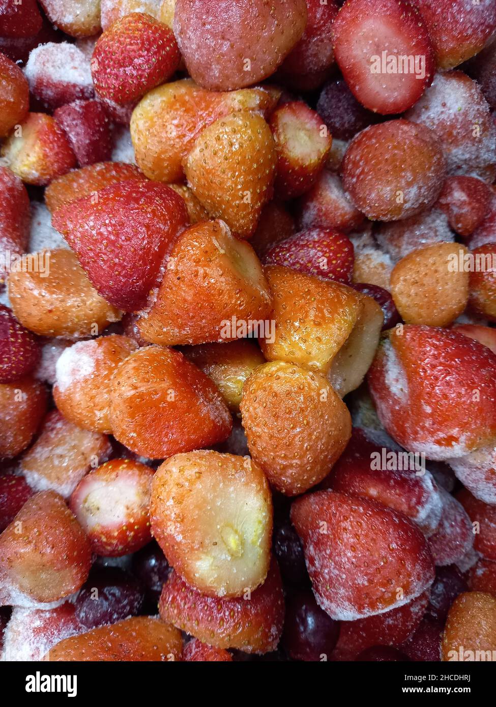 Berries of ripe red strawberries frozen on a display in a store. Stock Photo