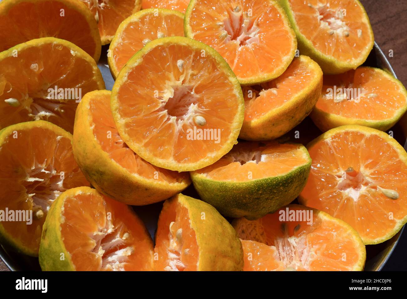 Orange, Malta fruits sliced in to half to take out juice. Grapefruit or limes. Citrus fruits half for juice preparation in juice center. background cl Stock Photo