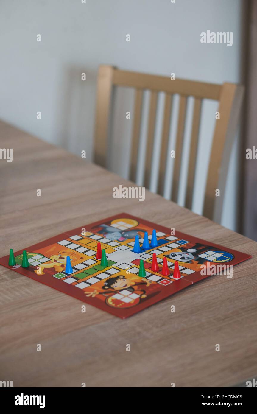 German board game Mensch Aergere Dich Nicht (Man, Don't Get Angry) on a table. Stock Photo