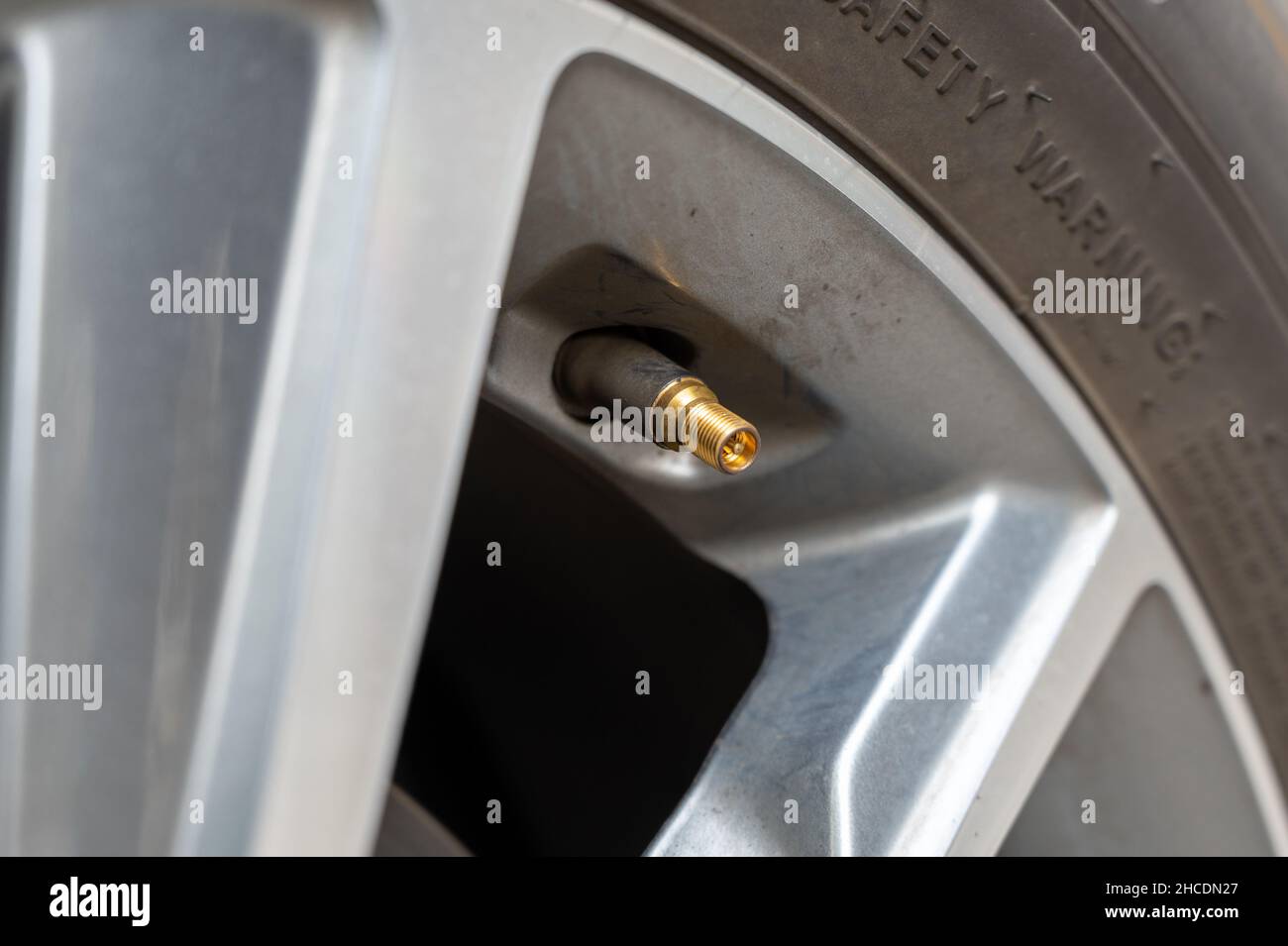 Air valve of a car tire close-up. Stock Photo