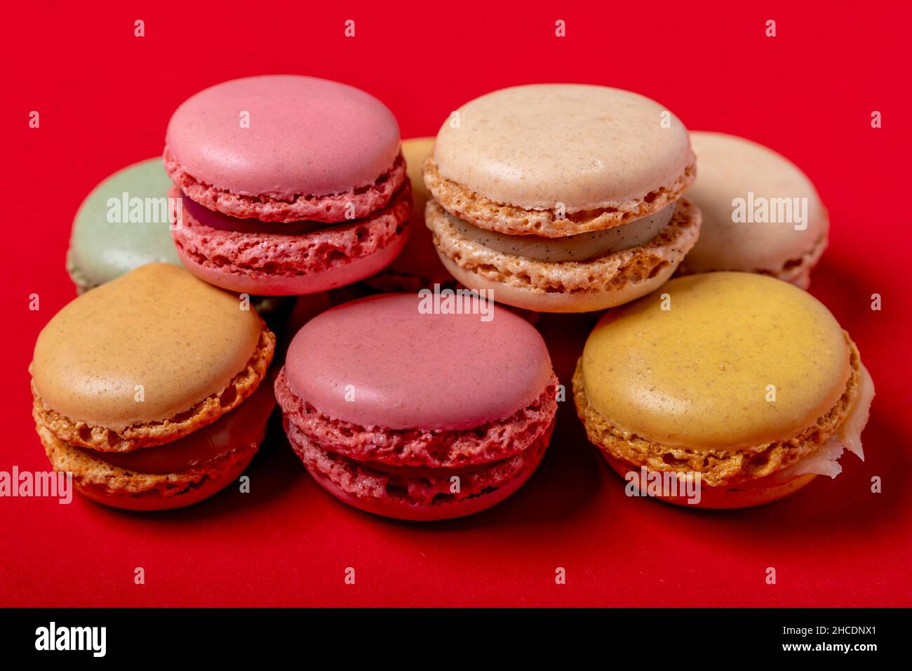 Colorful macarons on a bright red background Stock Photo