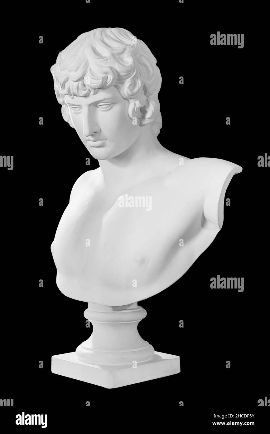 Gypsum copy of famous ancient statue Antinous bust isolated on a black background with clipping path. Plaster antique sculpture young man face Stock Photo
