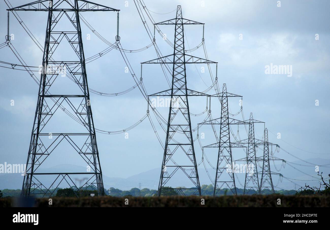 File photo dated 11/10/21 of electricity pylons in Cheshire. Soaring gas prices consigned a string of energy suppliers to the graveyard in 2021, and will lead to runaway household bills next year as the sector continues to struggle. Energy suppliers had been paying 54p per therm of gas at the beginning of the year. By September, that had reached more than £3 and peaked even further to £4.50 just before Christmas. Issue date: Tuesday December 28, 2021. Stock Photo