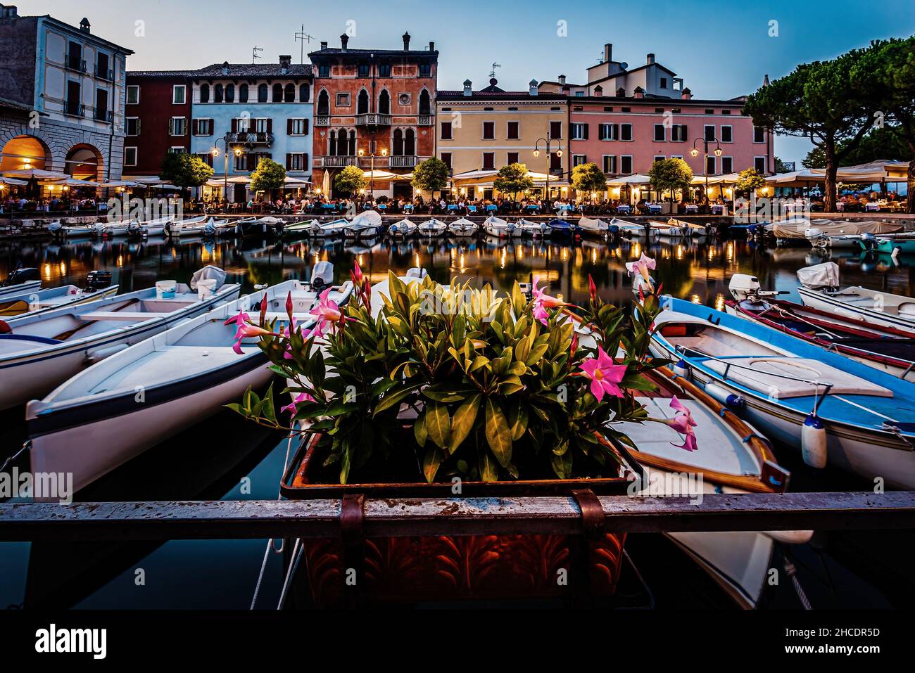 Blue hour view of Desenzano del Garda marina with open restaurants. Photo taken on 20th of August 2021 in Desenzano del Garda, Brescia province, Lomba Stock Photo