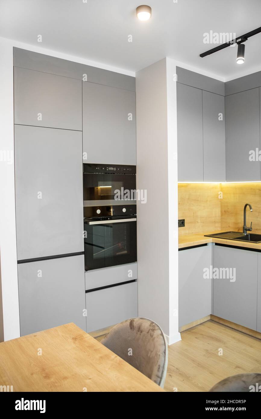 Light modern kitchen interior with gray tones. Cozy home Stock Photo