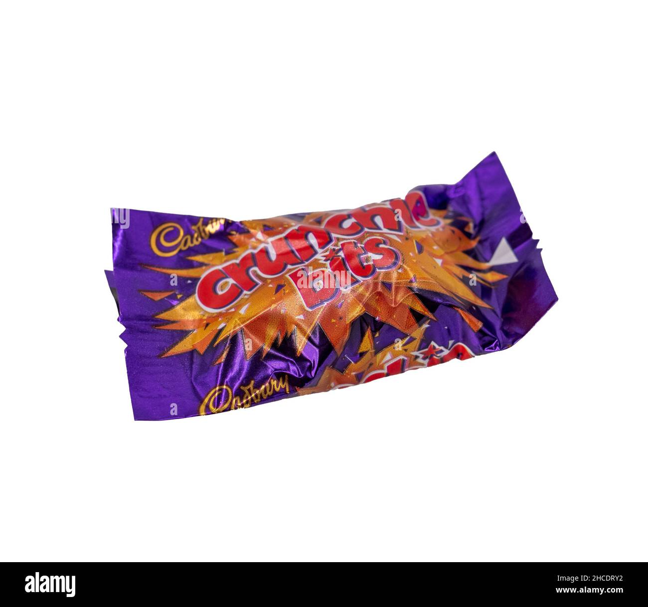Norwich, Norfolk, UK – December 2021. Close up of a Cadbury Crunchy Bits chocolate bar cut out isolated on a plain white background. This is just one Stock Photo