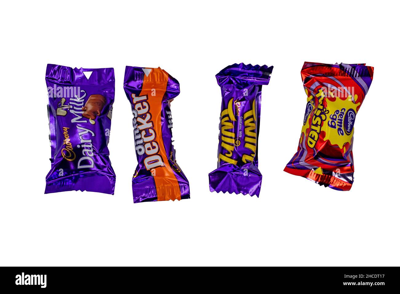 Norwich, Norfolk, UK – December 2021. Various individual bars of chocolate from a box of Cadbury Heroes chocolates cut out and isolated on a plain whi Stock Photo