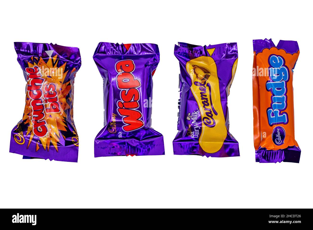 Norwich, Norfolk, UK – December 2021. Various individual bars of chocolate from a box of Cadbury Heroes chocolates cut out and isolated on a plain whi Stock Photo