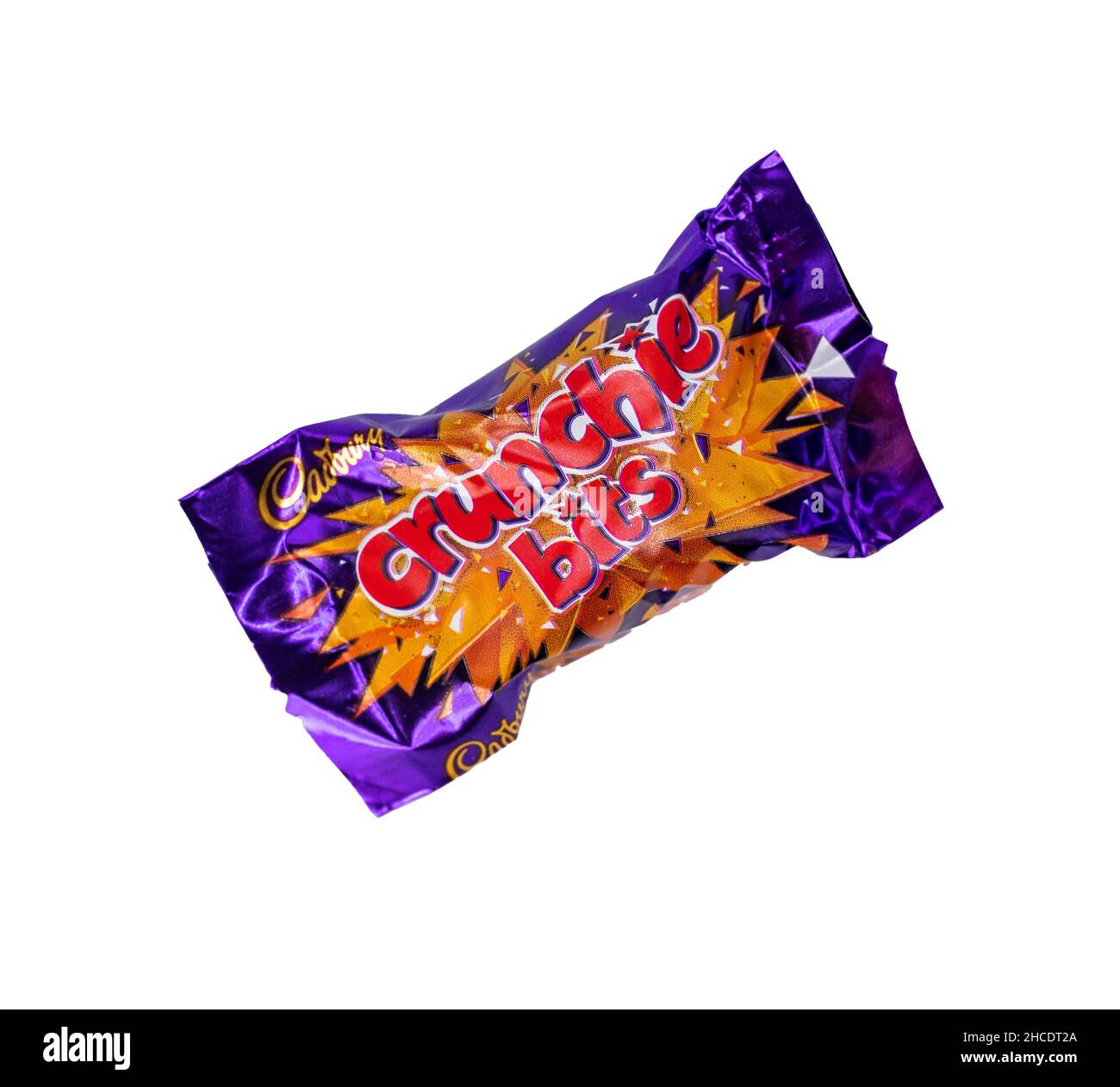 Norwich, Norfolk, UK – December 2021. Close up of a Cadbury Crunchy Bits chocolate bar cut out isolated on a plain white background. This is just one Stock Photo