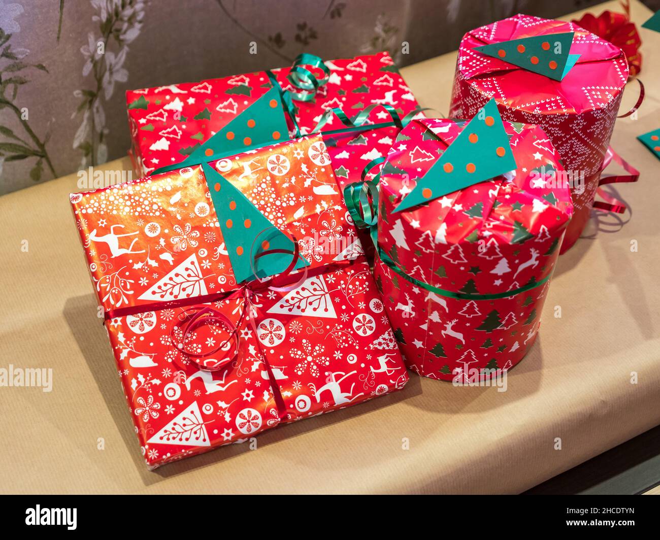 Group of Christmas presents wrapped in colorful wrapping paper Stock Photo