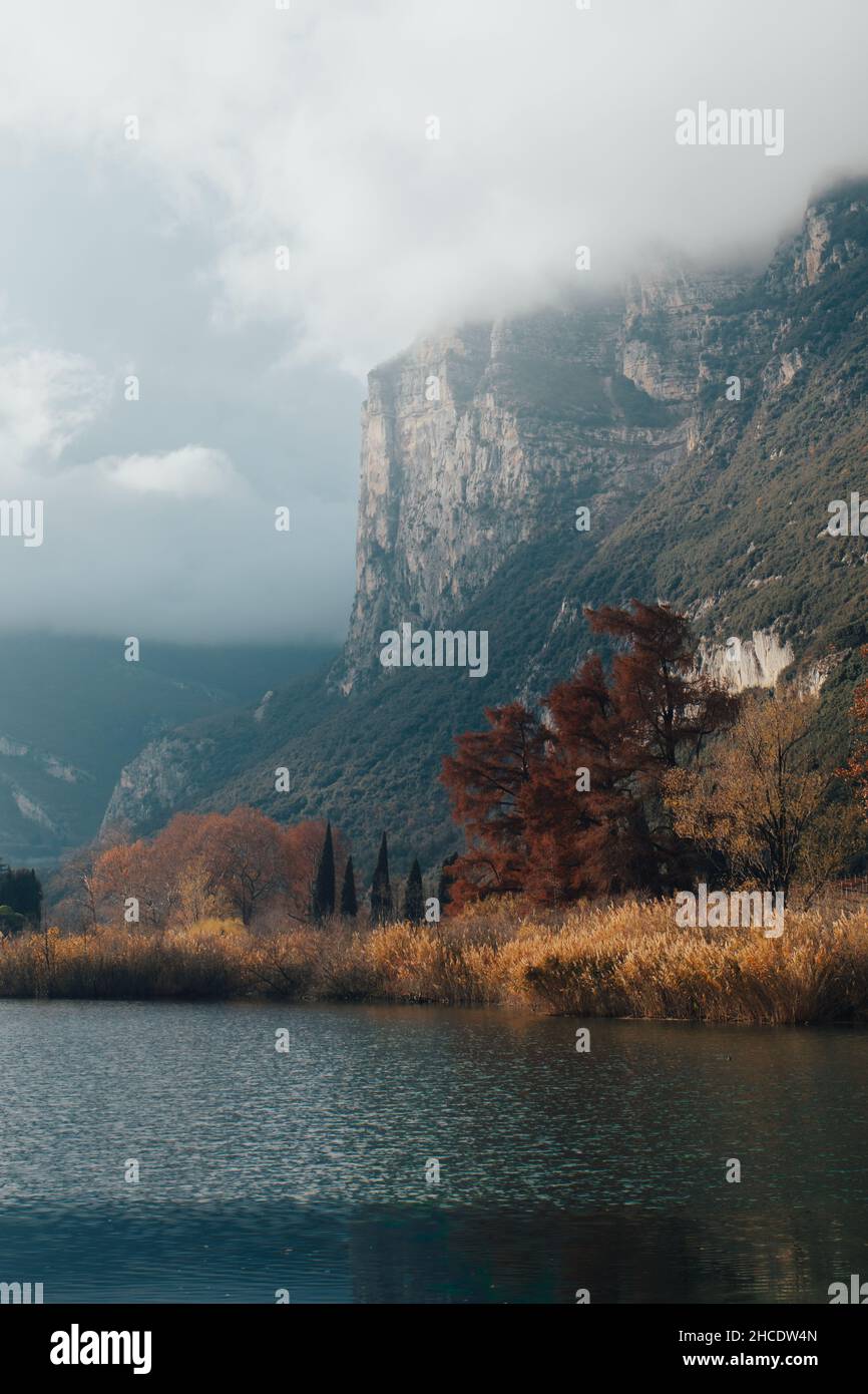 Vertical shot of Lago di Toblino in autumn. Lake in Trentino, Italy. Stock Photo