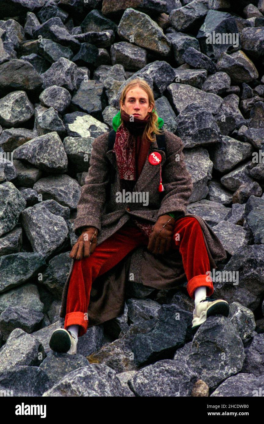 Berlin, Germany. Portrait of a Young adult, caucasian Musician and Music Producer , named: Leonard Wellington, sitting on a pile of Rocks and Stones insde a Graffiti Place. Stock Photo