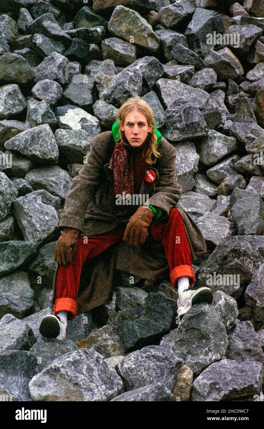 Berlin, Germany. Portrait of a Young adult, caucasian Musician and Music Producer , named: Leonard Wellington, sitting on a pile of Rocks and Stones insde a Graffiti Place. Stock Photo