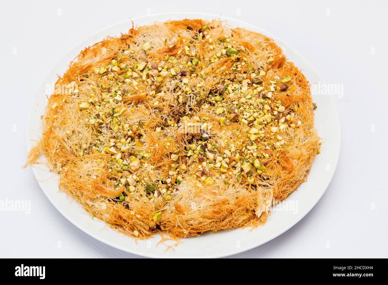Knafeh [Knafe] is a traditional Middle Eastern dessert made with spun