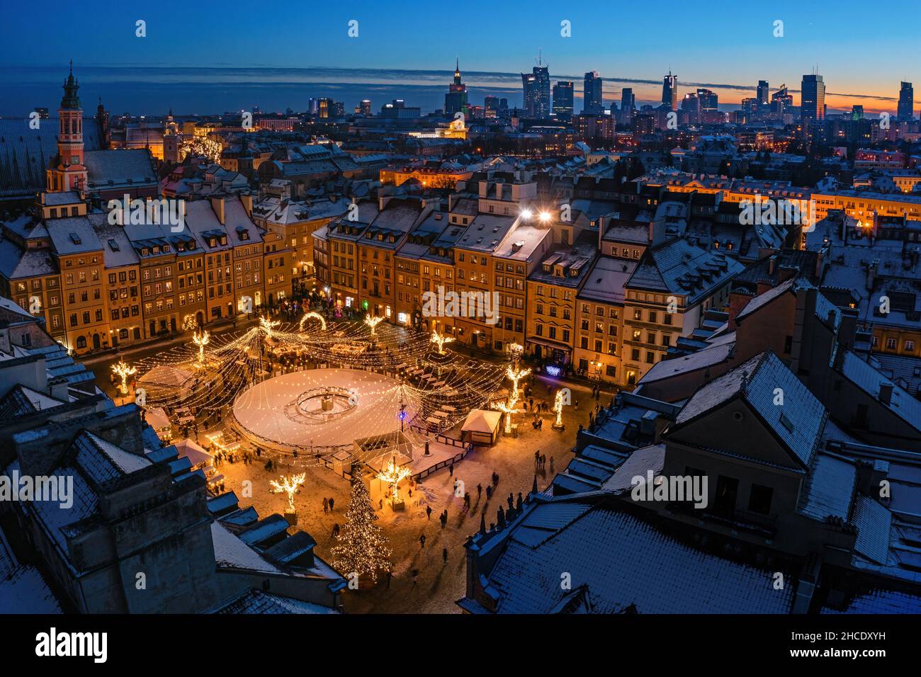 Warsaw, old town market decorated with christmas lights and city center winter aerial panorama at dusk Stock Photo