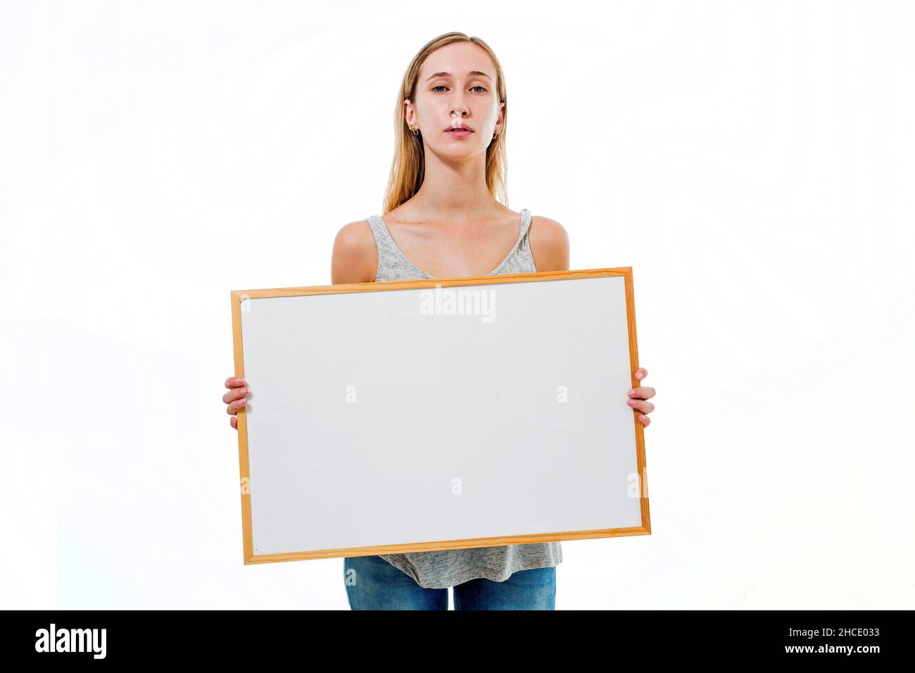 Young model holds a blank whiteboard ready for your text Stock Photo