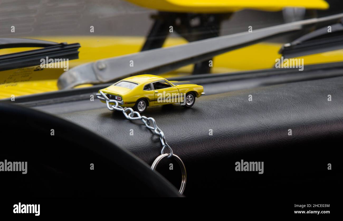 Closeup of the yellow car keychain in the car Stock Photo Alamy