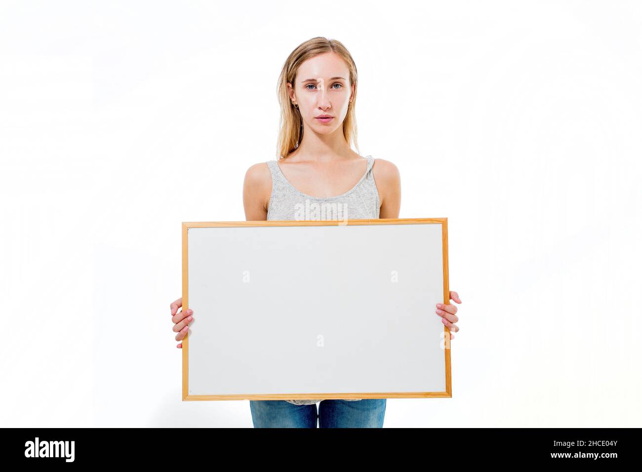 Young model holds a blank whiteboard ready for your text Stock Photo
