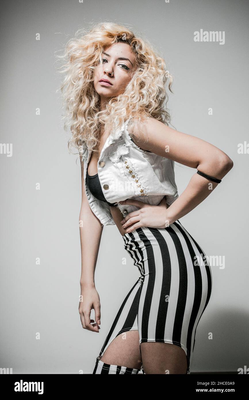 Flirting Young Hip female teen with blond curly hair Stock Photo