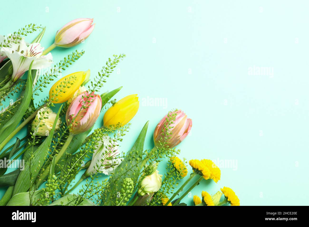 Hello spring concept with flowers on mint background Stock Photo