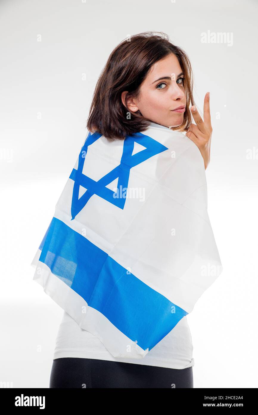 Portrait of a woman wrapped in the flag of Israel on white background Stock Photo