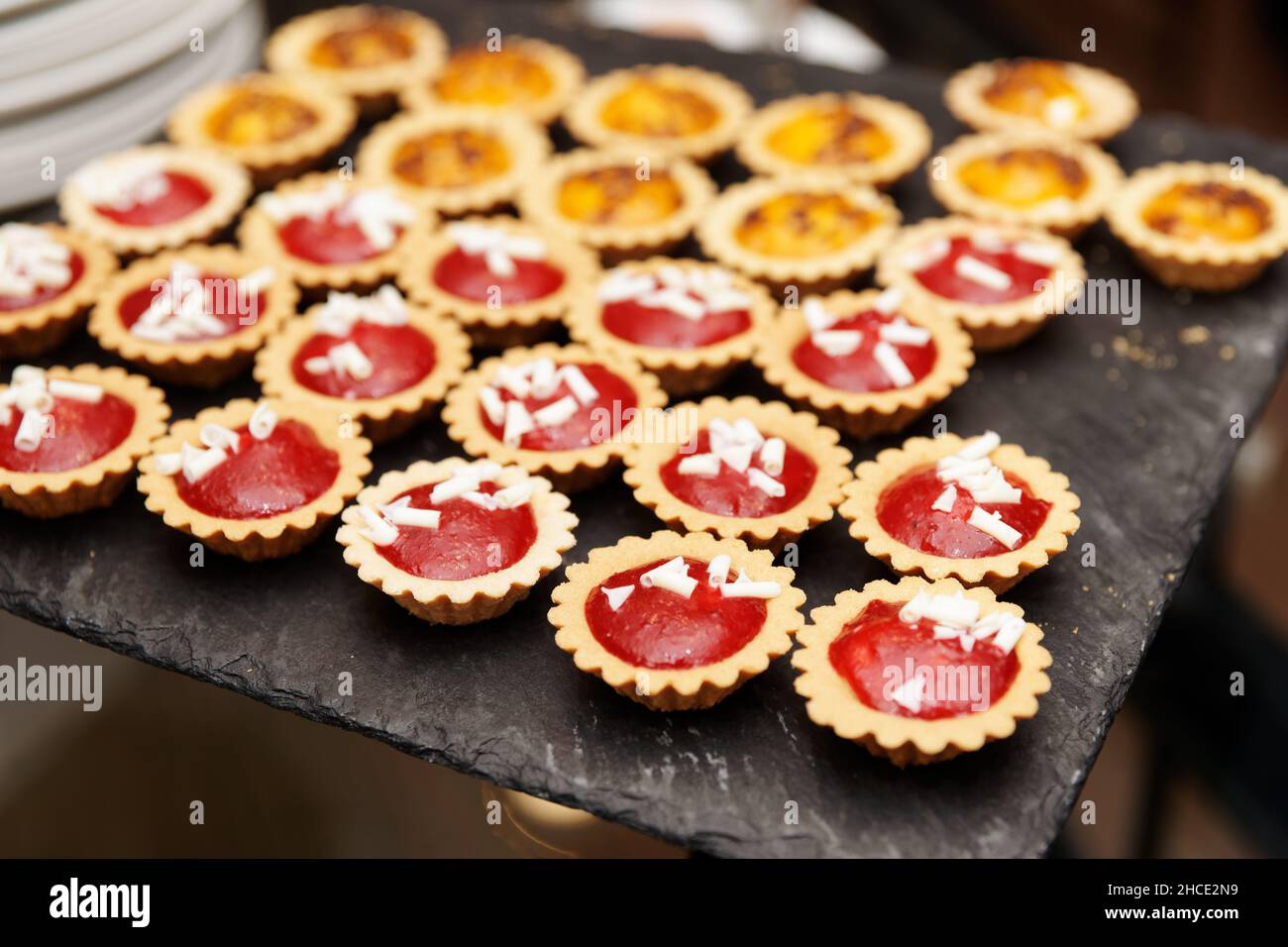 Tartlets with jam on banquet table, close-up Stock Photo