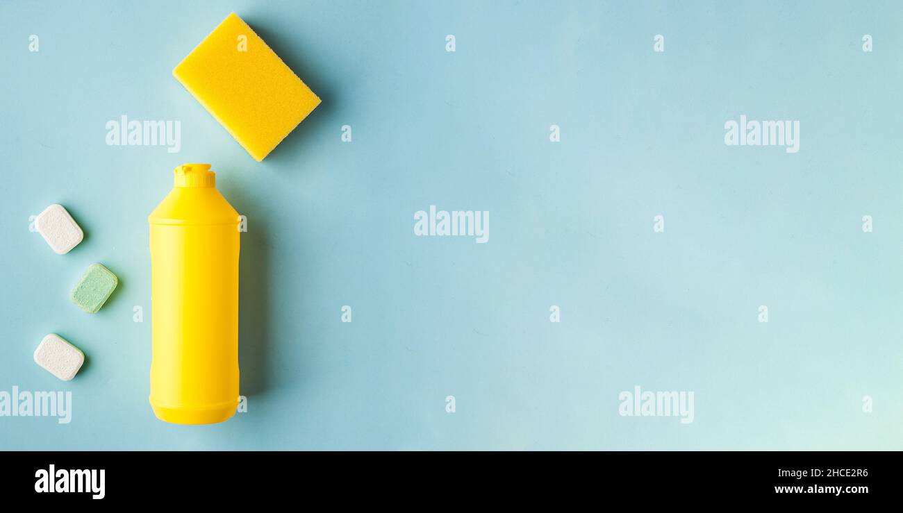 Liquid dishwashing liquid, dishwasher tablets on a blue background