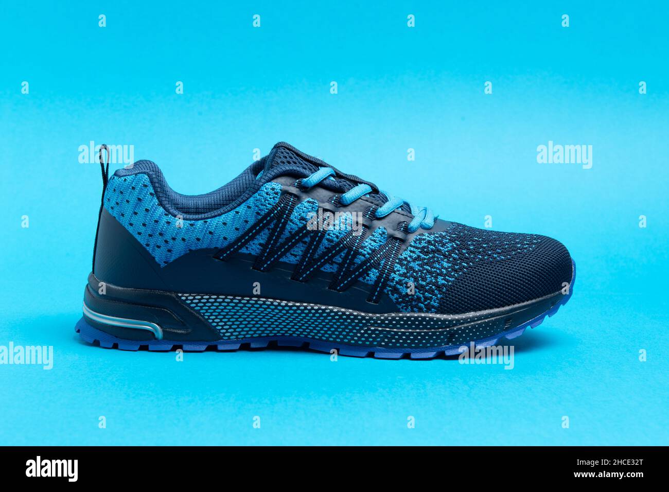 Blue sport shoe with colorful background. Running and podiatry concept. Stock Photo