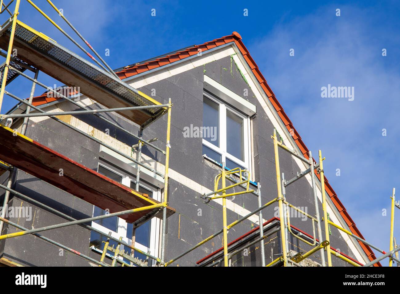 Thermal insulation of a house facade on a new building Stock Photo - Alamy