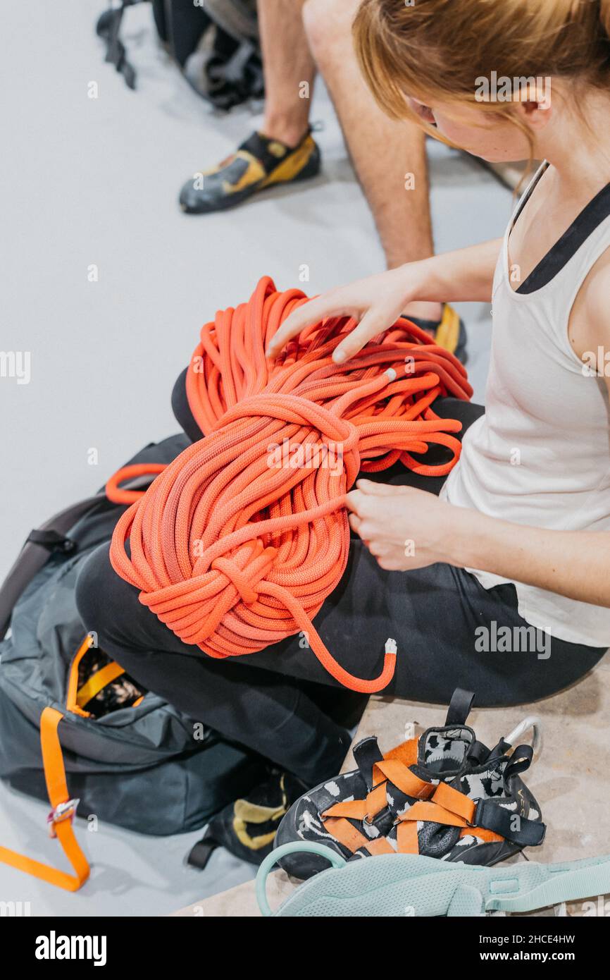 From above side view of crop anonymous female climber with special