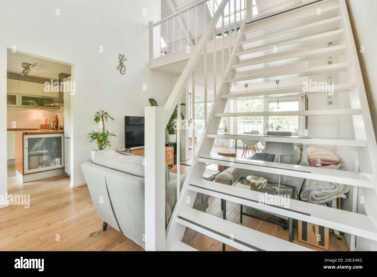 Staircase leading to modern living room interior with sofa and coffee