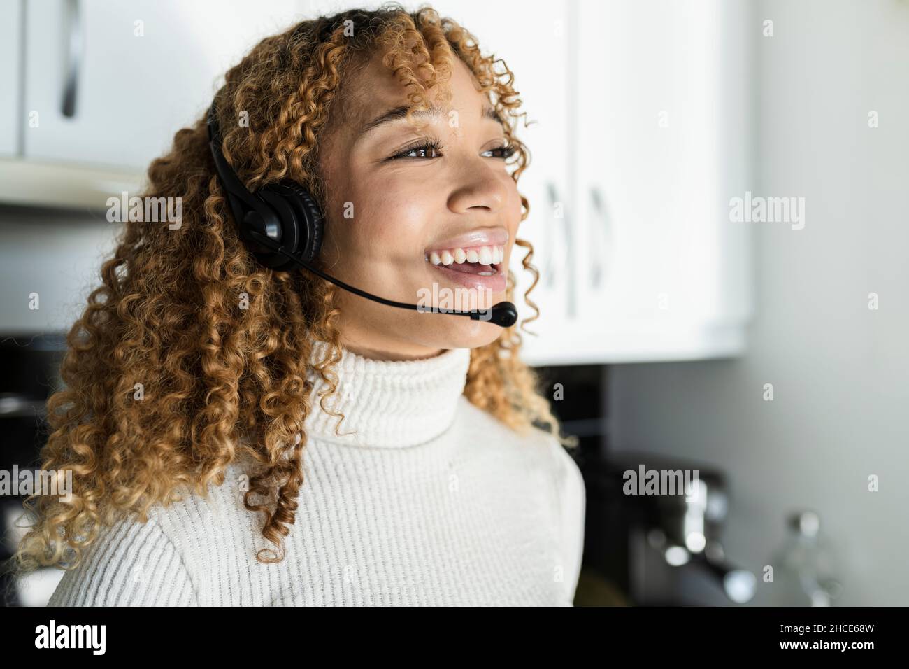 Positive charming African American female with curly hair wearing