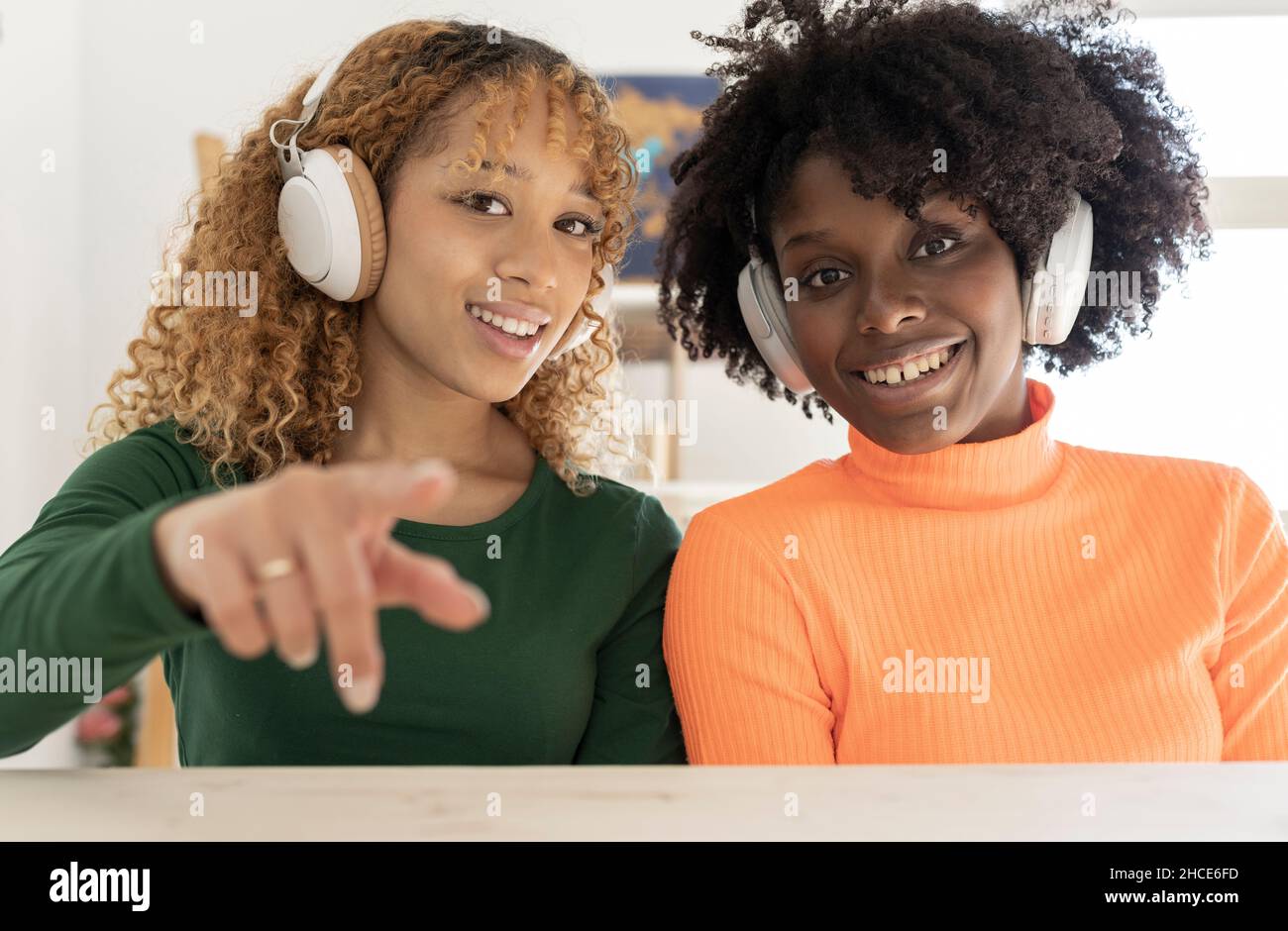 positive-african-american-female-friends-in-casual-clothes-and-with