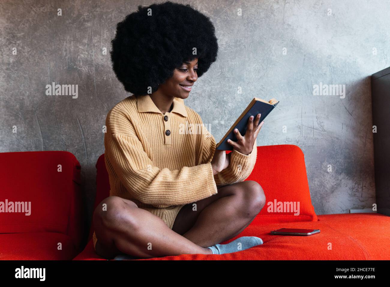 African woman sitting alone side view hi-res stock photography and ...