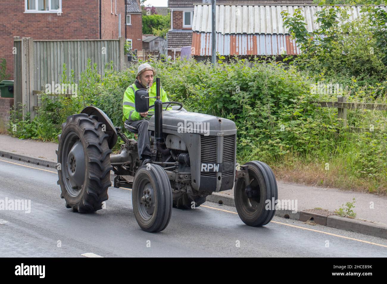 Massey Ferguson Tractor driver on vehicle. Prize possession. Retirement activity. Senior citizen. Focussed. Pride and joy.Only in Stalham. Norfolk. UK. Stock Photo