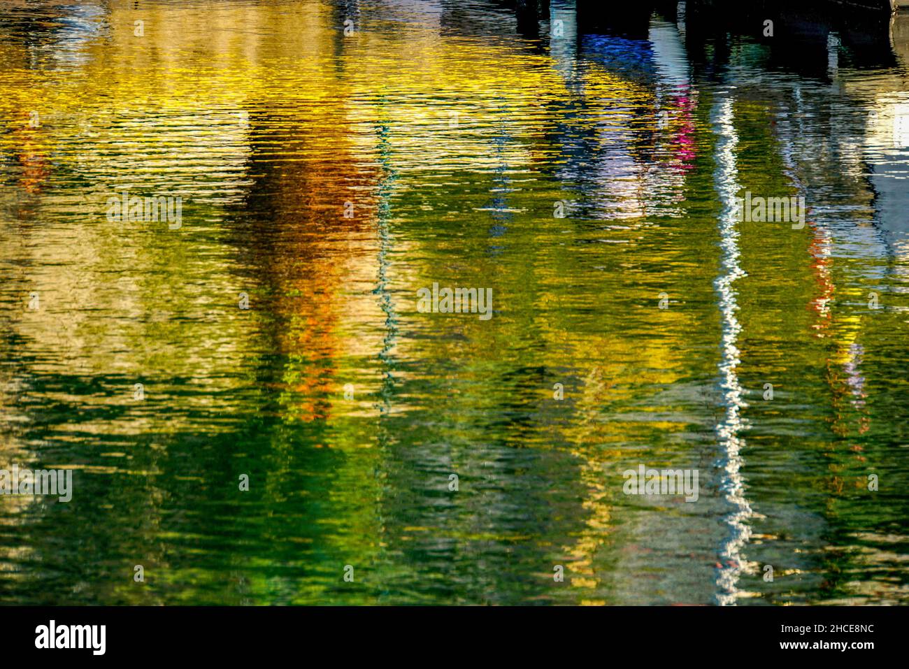 Boats reflecting in the water in a harbour Stock Photo - Alamy