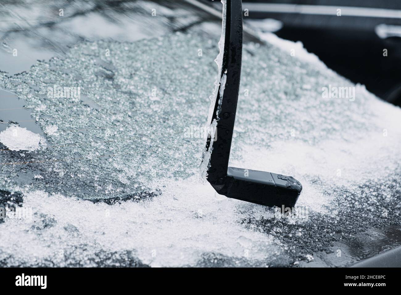 Windshield wiper raised up and icy car windshield. Leave Windshield