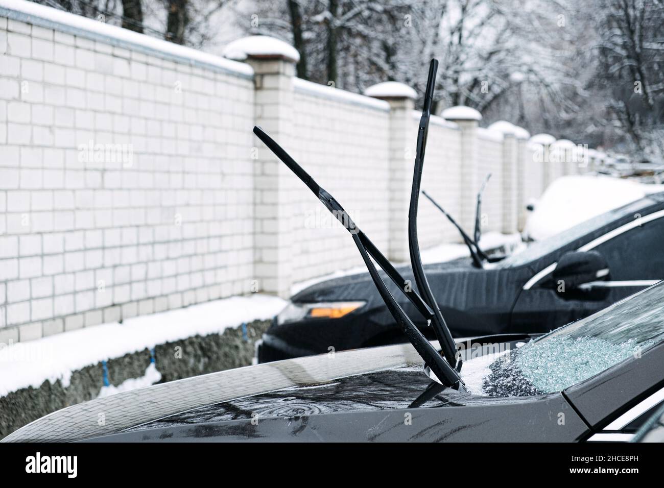 Windshield wiper raised up and icy car windshield. Leave Windshield