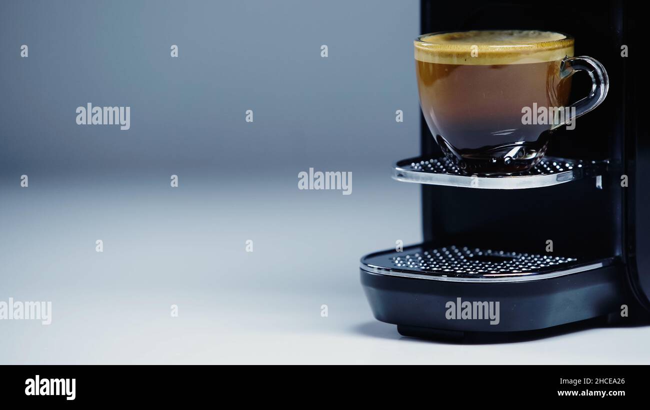 https://c8.alamy.com/comp/2HCEA26/automatic-coffee-maker-with-glass-cup-of-coffee-on-greystock-image-2HCEA26.jpg