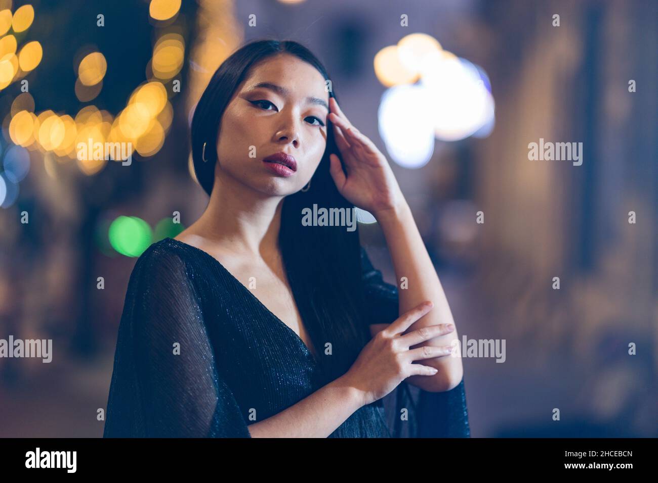 Beauty portrait of Young Asian woman touching her hair on the street at ...