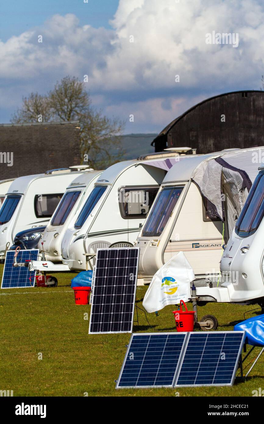 Caravans on a caravan rally using small solar panels to provide power while camping without electricity Stock Photo