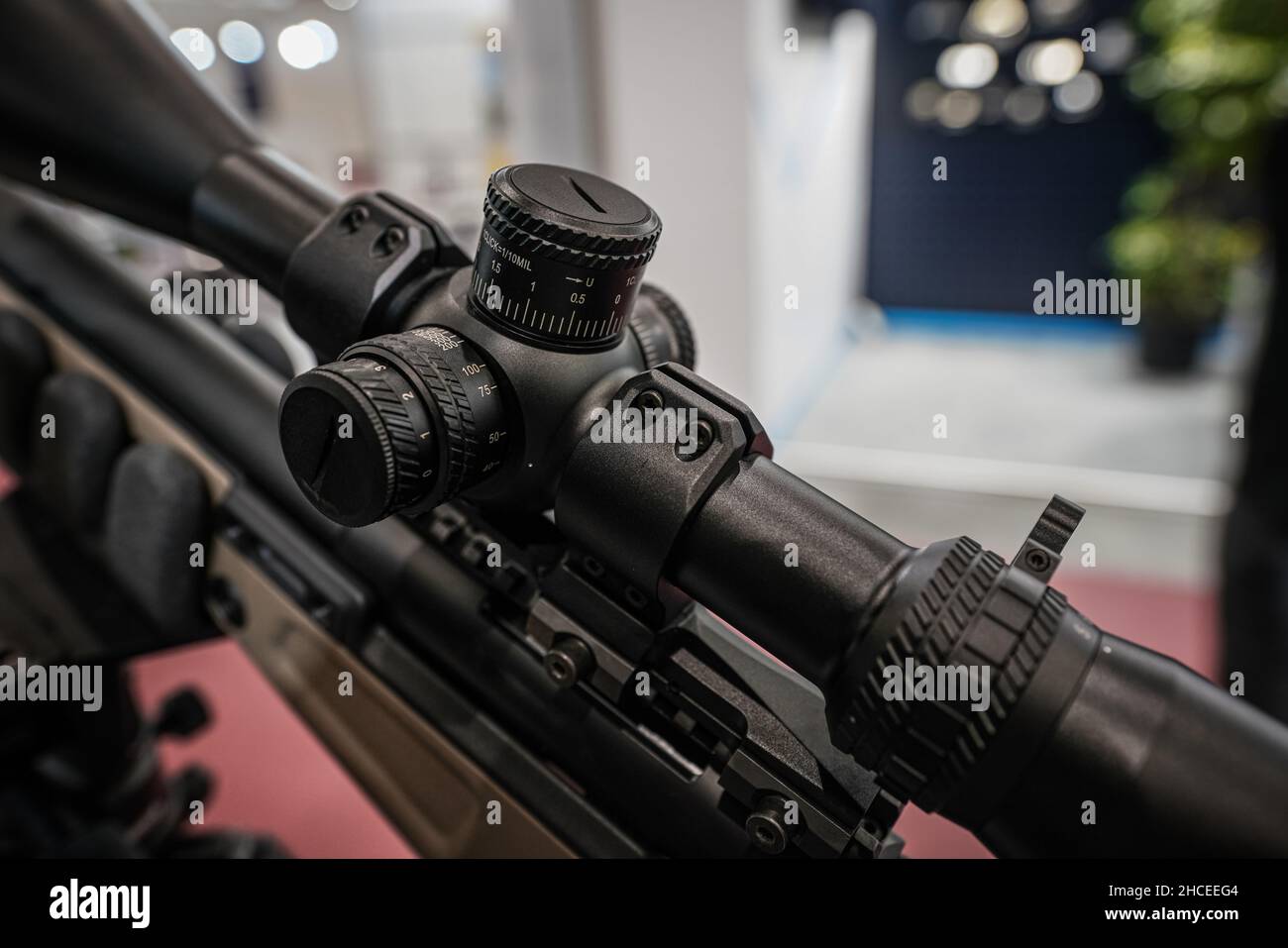 Black shooting scope optics mounted on rifle displayed at weapons