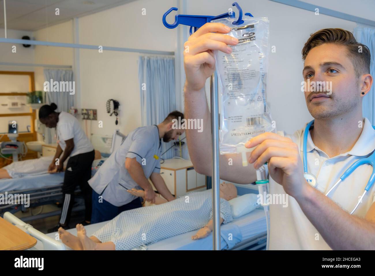 Student nurses training realistic medical dummy Stock Photo