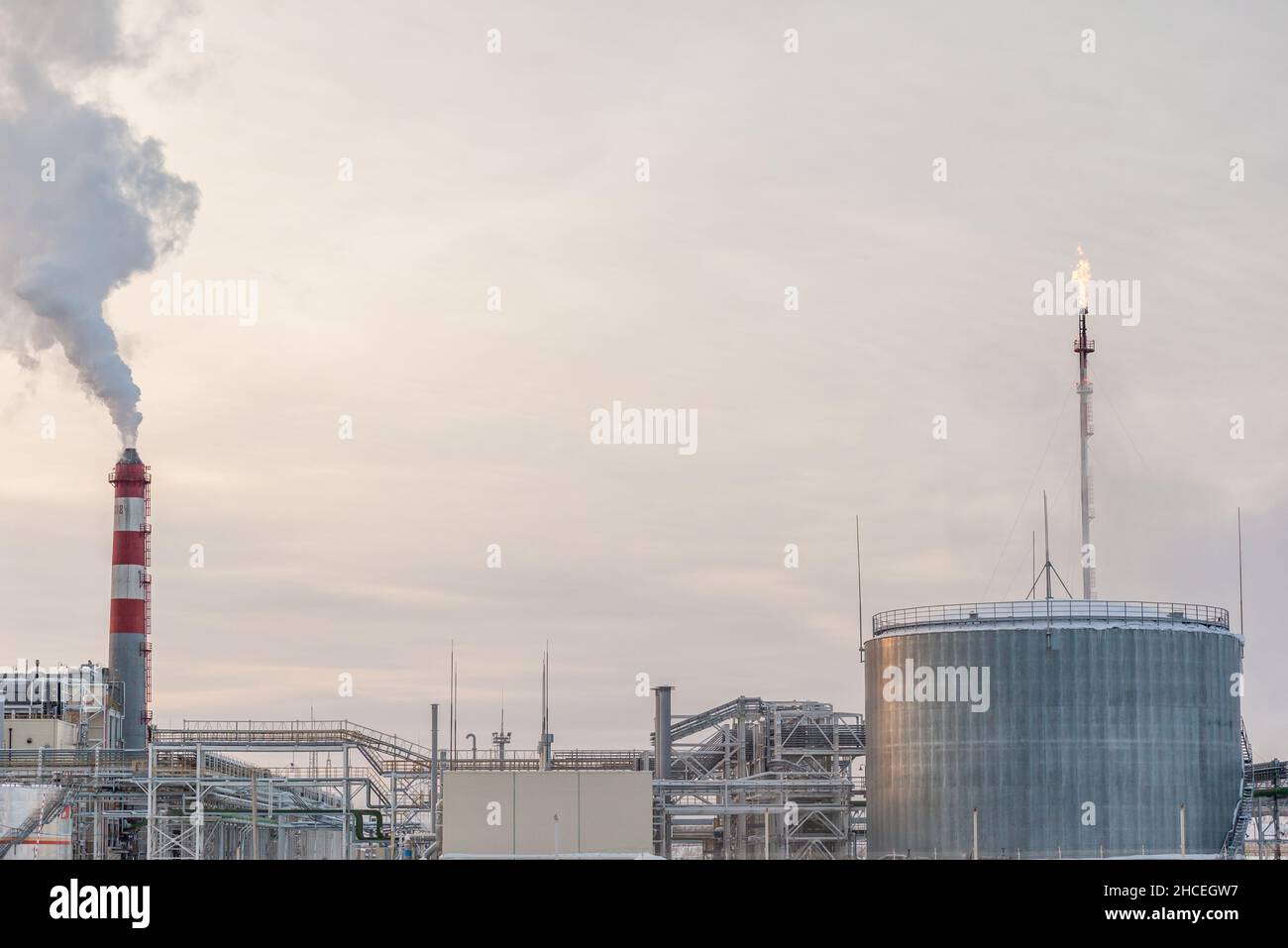 Petrochemical industrial factory of heavy industry, power refinery production with smoke pollution.Thick smoke is coming from the factory's chimney. s Stock Photo