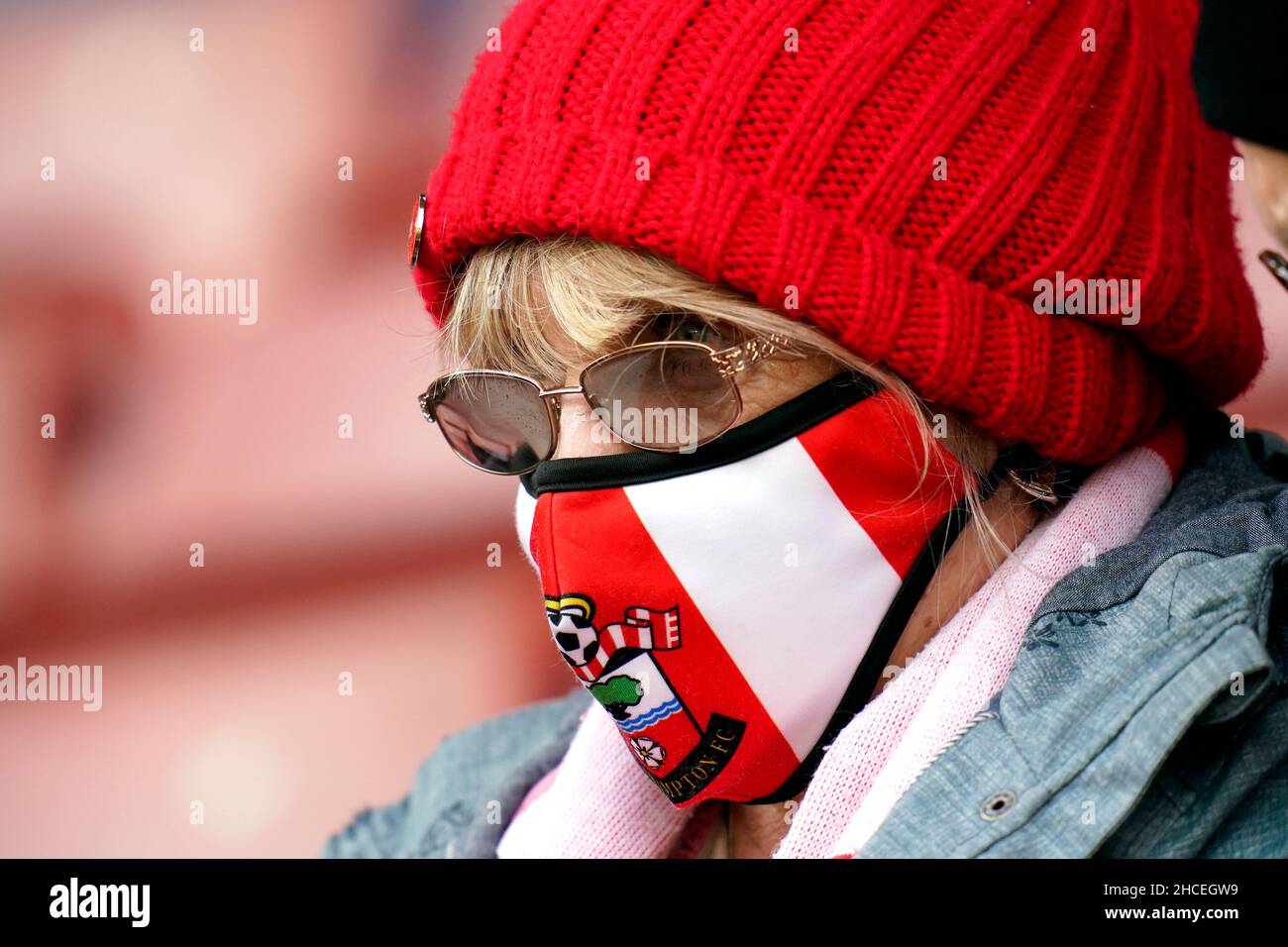 A Southampton fan wears a branded face mask before the Premier League
